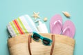 Summer holiday concept.Top view of beach bag with flip flops,beach towel,sunglasses,sea shells and starfish Royalty Free Stock Photo