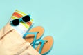 Summer holiday concept.Top view of blue flip flops,beach towel, blue sunglasses and beach bag with copy space Royalty Free Stock Photo