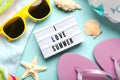 Summer holiday concept. Top view of light box with the text I love summer,flip flops,beach towel,sunglasses and starfish Royalty Free Stock Photo