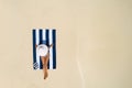 Summer holiday fashion concept - tanning girl wearing sun hat at the beach on a white sand shot from above.Top view from drone. Royalty Free Stock Photo