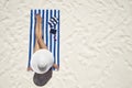 Summer holiday fashion concept - tanning woman wearing sun hat a Royalty Free Stock Photo