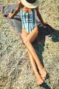 Top view tanning woman in straw hat and swimsuit lying and sunbathing on beach. Royalty Free Stock Photo