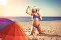 Summer holiday, girl traveling, relax on the beach on a background of water. Fun summer party in the trip. Woman on vacation