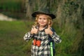 Summer holiday. Kid with binoculars hiking at nature. Little explorer. Outdoor recreation and adventures with kids Royalty Free Stock Photo