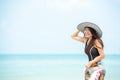 Summer Holiday. Lifestyle smiling asian woman wearing bikini fashion summer trips relax on the sandy ocean beach. Happy woman enj