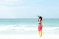 Summer Holiday. Lifestyle woman chill holding big white hat and wearing bikini fashion summer trips walking on the sandy ocean bea Royalty Free Stock Photo