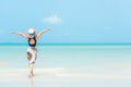 Summer Holiday. Lifestyle woman chill holding big white hat and wearing bikini fashion summer trips walking on the sandy ocean bea Royalty Free Stock Photo
