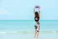 Summer Holiday. Lifestyle woman chill holding big white hat and wearing bikini fashion summer trips walking on the sandy ocean bea Royalty Free Stock Photo