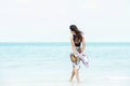 Summer Holiday. Lifestyle woman chill holding big white hat and wearing fashion summer trips walking on the sandy ocean beach. Royalty Free Stock Photo