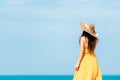 Summer Holiday. Lifestyle woman chill holding big white hat and wearing yellow dress fashion summer trips standing chill on the sa Royalty Free Stock Photo