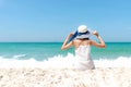 Summer Holiday. Lifestyle woman white dress wearing fashion summer trips sitting on the sandy ocean beach. Happy woman enjoy and r Royalty Free Stock Photo