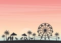 Summer holiday. Silhouette palm tree with Ferris wheel and beach chair on beach under sky sunset. Royalty Free Stock Photo