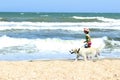 Young Little Girl And Golden Retriever Dog Running On The Beach. Royalty Free Stock Photo