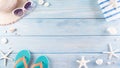 Summer holiday, travel and vacation concept. Sunglasses, starfish, beach hat, flip flop and sea shell on pastel blue wooden Royalty Free Stock Photo