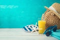 Summer holiday vacation background with orange juice, beach fashion bag and flip flops Royalty Free Stock Photo