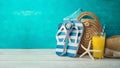 Summer holiday vacation background with orange juice, beach fashion bag and flip flops Royalty Free Stock Photo