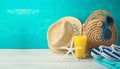 Summer holiday vacation background with orange juice, beach fashion bag and flip flops Royalty Free Stock Photo