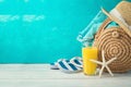 Summer holiday vacation background with orange juice, beach fashion bag and flip flops Royalty Free Stock Photo