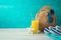 Summer holiday vacation background with orange juice, beach fashion bag and flip flops Royalty Free Stock Photo