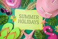 Summer holiday vacation concept with paper note, beach accessories and tropical leaves on green background Royalty Free Stock Photo