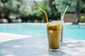 Summer holiday vacation with frappe refreshment by luxury poolside. Two ice coffee cups with straws behind resort summer pool bar Royalty Free Stock Photo