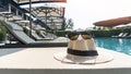 Summer holiday vacation relaxation at resort hotel swimming pool with hat and sunglasses to protect from UV sunlight Royalty Free Stock Photo