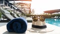 Summer holiday vacation relaxation at resort hotel swimming pool with hat and sunglasses to protect from UV sunlight Royalty Free Stock Photo