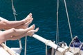 Summer holiday on the yacht. Female and male feet on blue sea Royalty Free Stock Photo