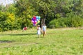 Summer holidays, celebration and dating concept - couple with colorful balloons in nature Royalty Free Stock Photo