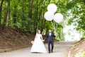 Summer holidays, celebration and wedding concept - couple with colorful balloons Royalty Free Stock Photo