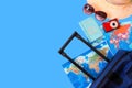 Summer holidays concept. Travel, tourism and vacation concept background. Traveler accessories. Flat lay. Blue suitcase with trav