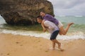Summer holidays lifestyle portrait of young beautiful and sweet Asian Korean couple in love walking on the beach together enjoying