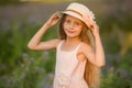 Summer holidays, nature, childhood, beauty. Portrait of child girl in hat in meadow, golden hour Royalty Free Stock Photo