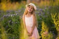 Summer holidays, nature, childhood, beauty. Portrait of child girl in hat in meadow, golden hour Royalty Free Stock Photo