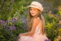 Summer holidays, nature, childhood, beauty. Portrait of child girl in hat in meadow, golden hour Royalty Free Stock Photo