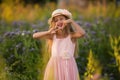 Summer holidays, nature, childhood, beauty. Portrait of child girl in hat in meadow, golden hour Royalty Free Stock Photo