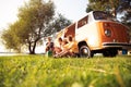 Summer holidays, road trip, vacation, travel and people concept - smiling young hippie friends having fun over minivan Royalty Free Stock Photo