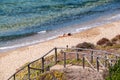 Sardinia. Arbus. Costa Verde touristic district. Woman sunbathes on the shore of Gutturu de Flumini beach, in Iglesiente region