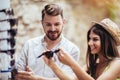 Young couple of tourists buying new sunglasses in street stall outdoor Royalty Free Stock Photo