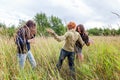 Summer holidays vacation happy people concept. Group of three friends boy and two girls dancing and having fun together outdoors. Royalty Free Stock Photo