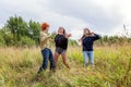 Summer holidays vacation happy people concept. Group of three friends boy and two girls dancing and having fun together outdoors. Royalty Free Stock Photo