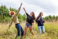 Summer holidays vacation happy people concept. Group of three friends boy and two girls dancing and having fun together outdoors. Royalty Free Stock Photo