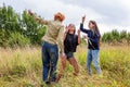 Summer holidays vacation happy people concept. Group of three friends boy and two girls dancing and having fun together outdoors. Royalty Free Stock Photo