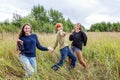 Summer holidays vacation happy people concept. Group of three friends boy and two girls dancing and having fun together outdoors. Royalty Free Stock Photo