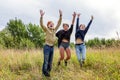 Summer holidays vacation happy people concept. Group of three friends boy and two girls jumping, dancing and having fun together Royalty Free Stock Photo