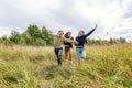 Summer holidays vacation happy people concept. Group of three friends boy and two girls running and having fun together outdoors. Royalty Free Stock Photo