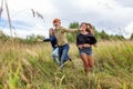 Summer holidays vacation happy people concept. Group of three friends boy and two girls running and having fun together outdoors. Royalty Free Stock Photo