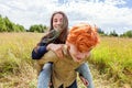 Summer holidays vacation happy people concept. Loving couple having fun in nature outdoors. Happy young man piggybacking Royalty Free Stock Photo