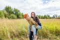Summer holidays vacation happy people concept. Loving couple having fun in nature outdoors. Happy young man piggybacking his Royalty Free Stock Photo
