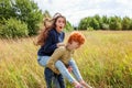 Summer holidays vacation happy people concept. Loving couple having fun in nature outdoors. Happy young man piggybacking Royalty Free Stock Photo
